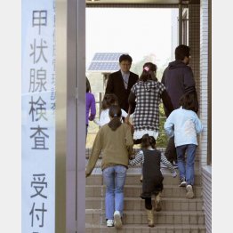 甲状腺検査に向かう子どもたち＝福島市の県立医大病院・２０１１年１０月（Ｃ）共同通信社