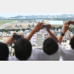 沖縄の普天間基地の写真を撮る修学旅行生（提供写真）