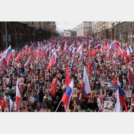 対独戦勝記念日も“国家総動員”（国旗と遺影の写真を持ち、「不滅の連隊」行進で沸くロシア国民）／（Ｃ）ロイター